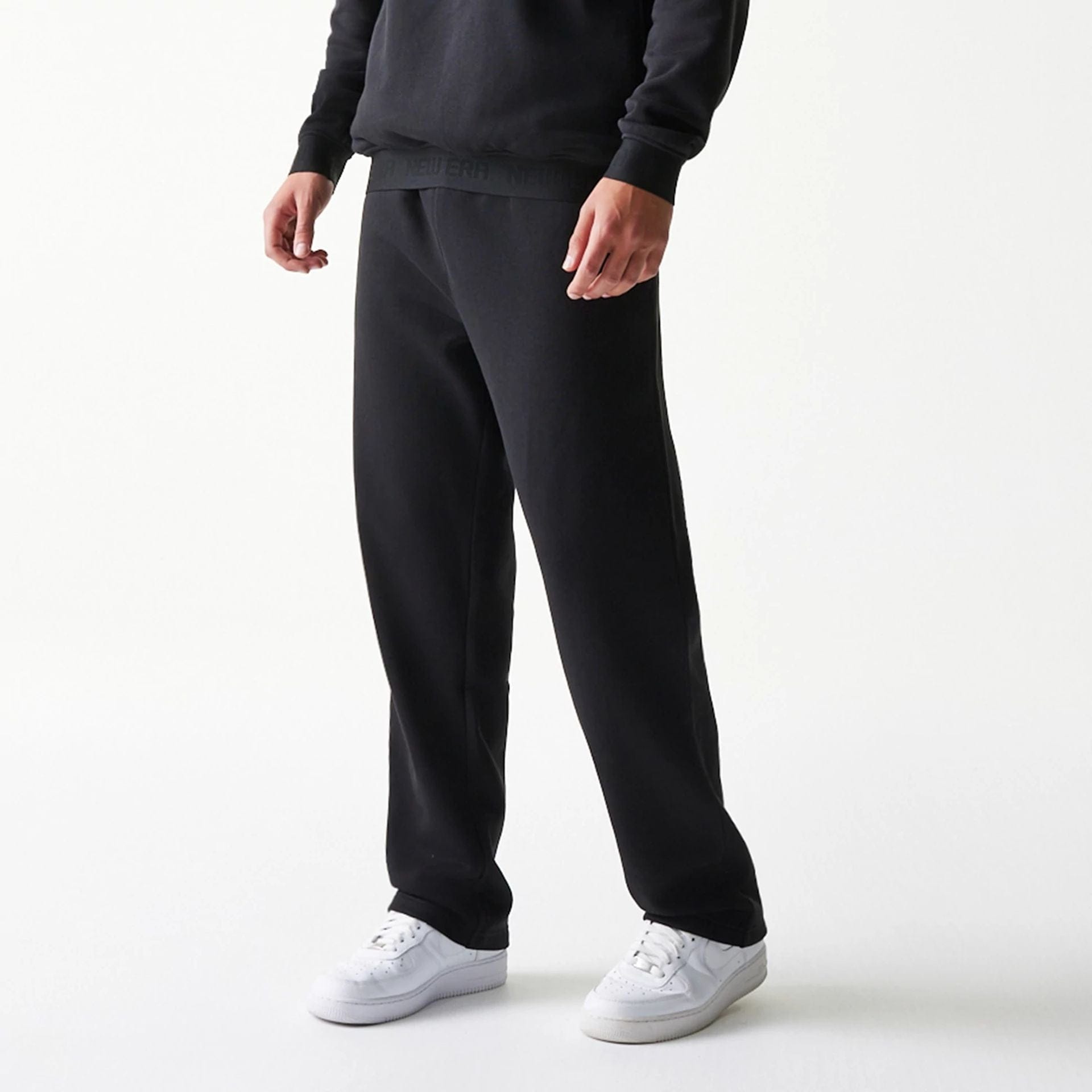 The model is wearing this New Era Tech Straight Leg Joggers in black. 3