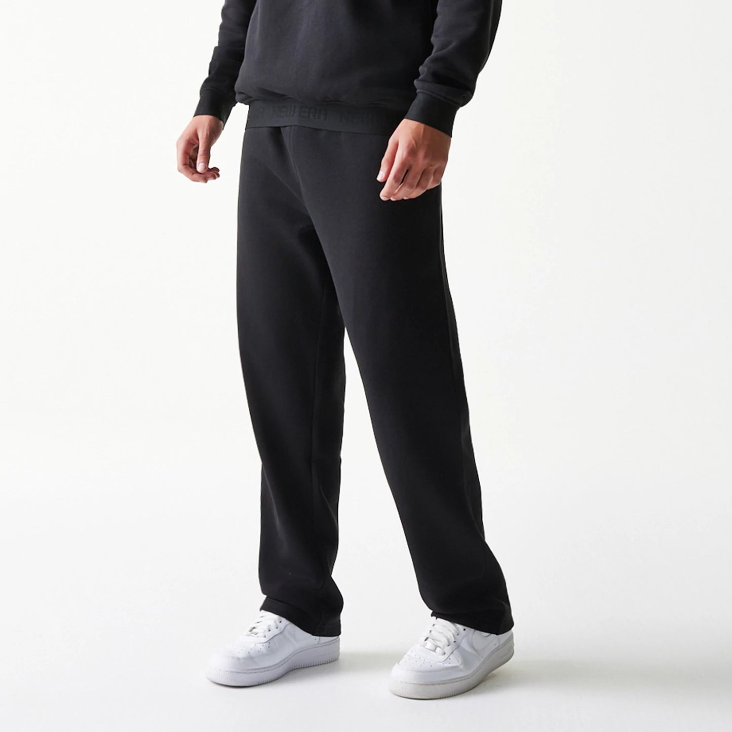 The model is wearing this New Era Tech Straight Leg Joggers in black on black. 3