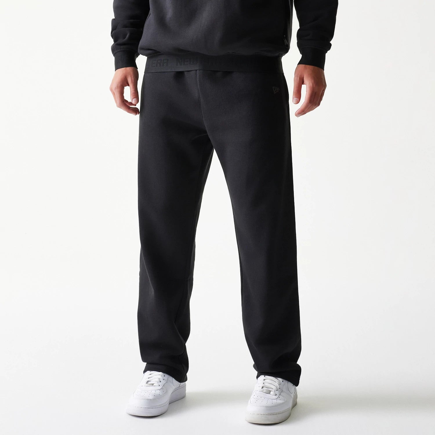 The model is wearing this New Era Tech Straight Leg Joggers in black on black. 4