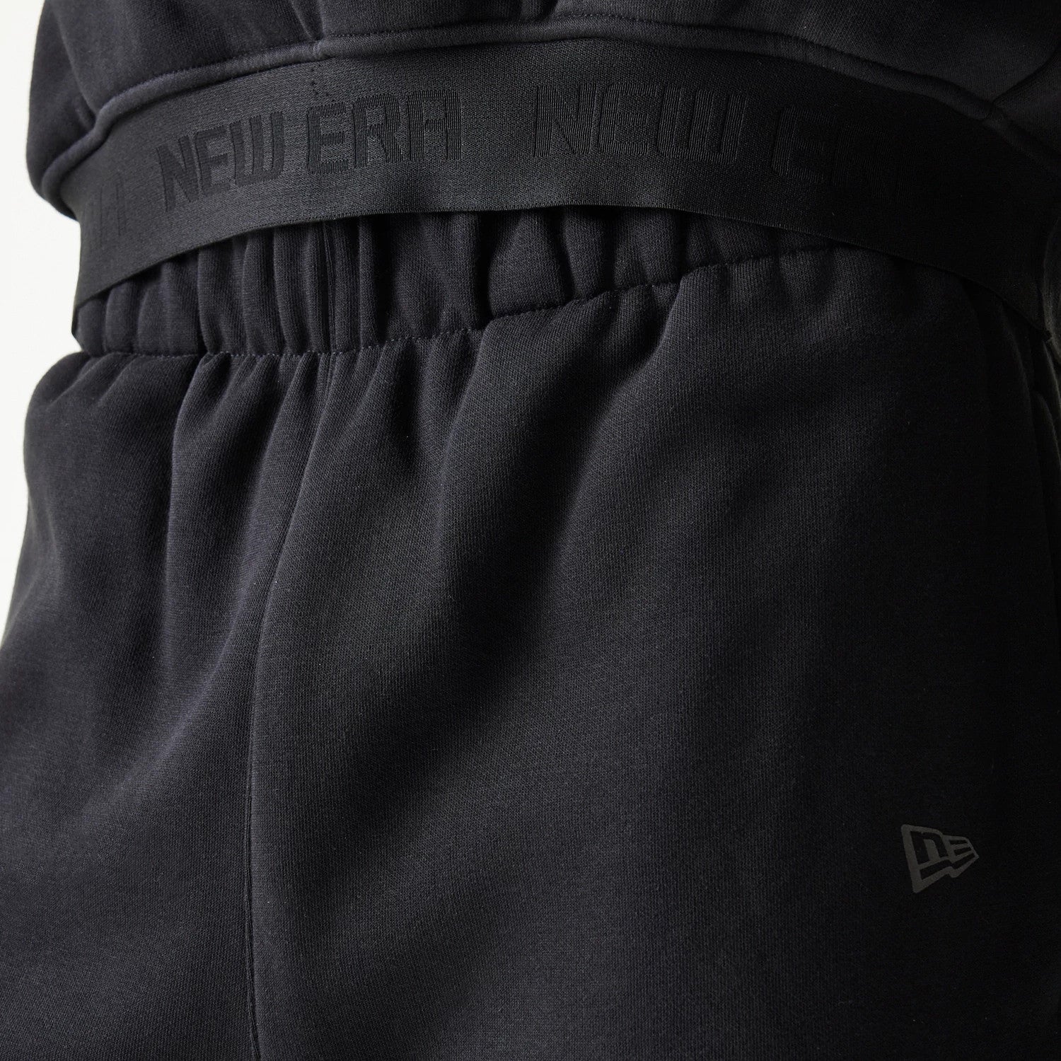 The model is wearing this New Era Tech Straight Leg Joggers in black on black. 6