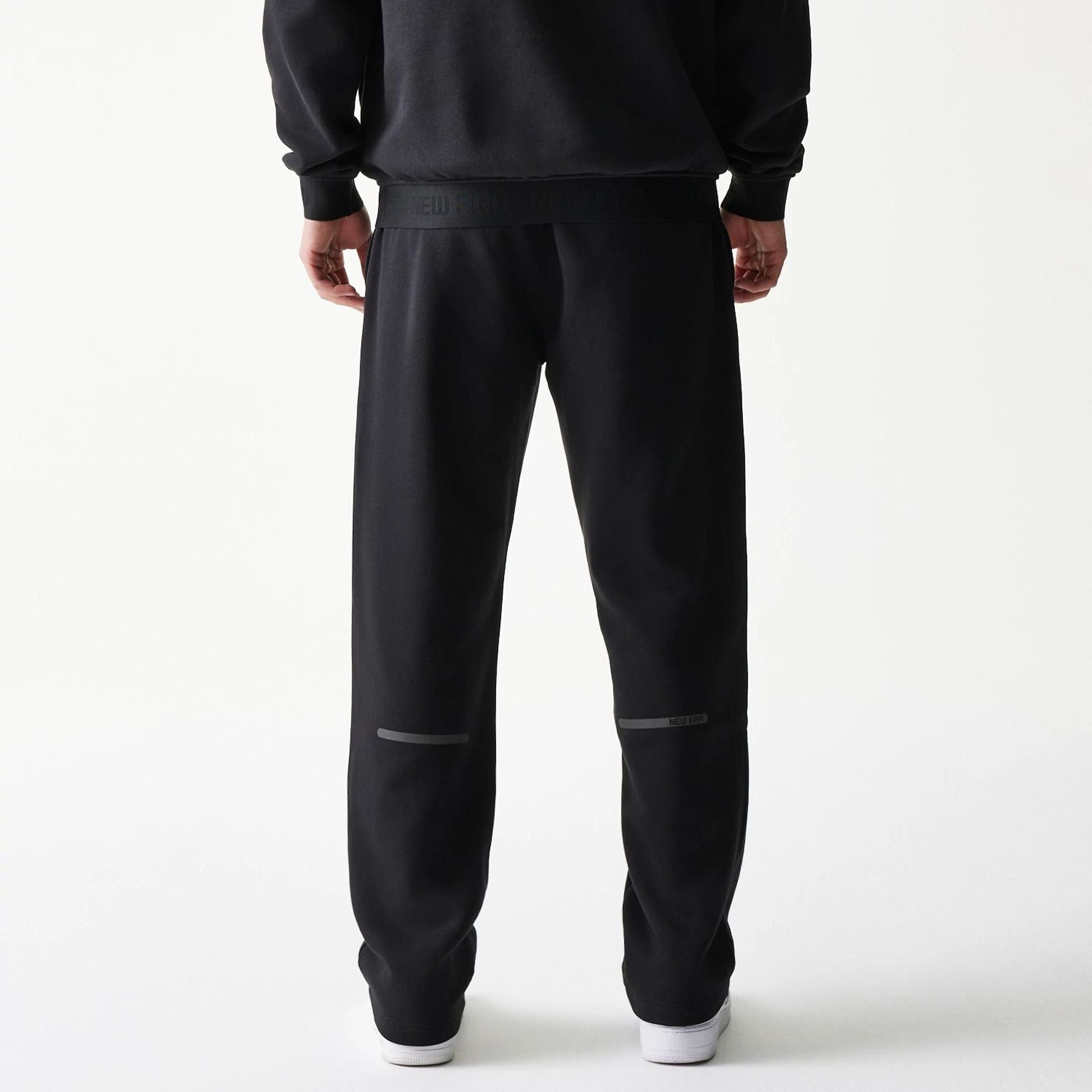 The model is wearing this New Era Tech Straight Leg Joggers in black. 2