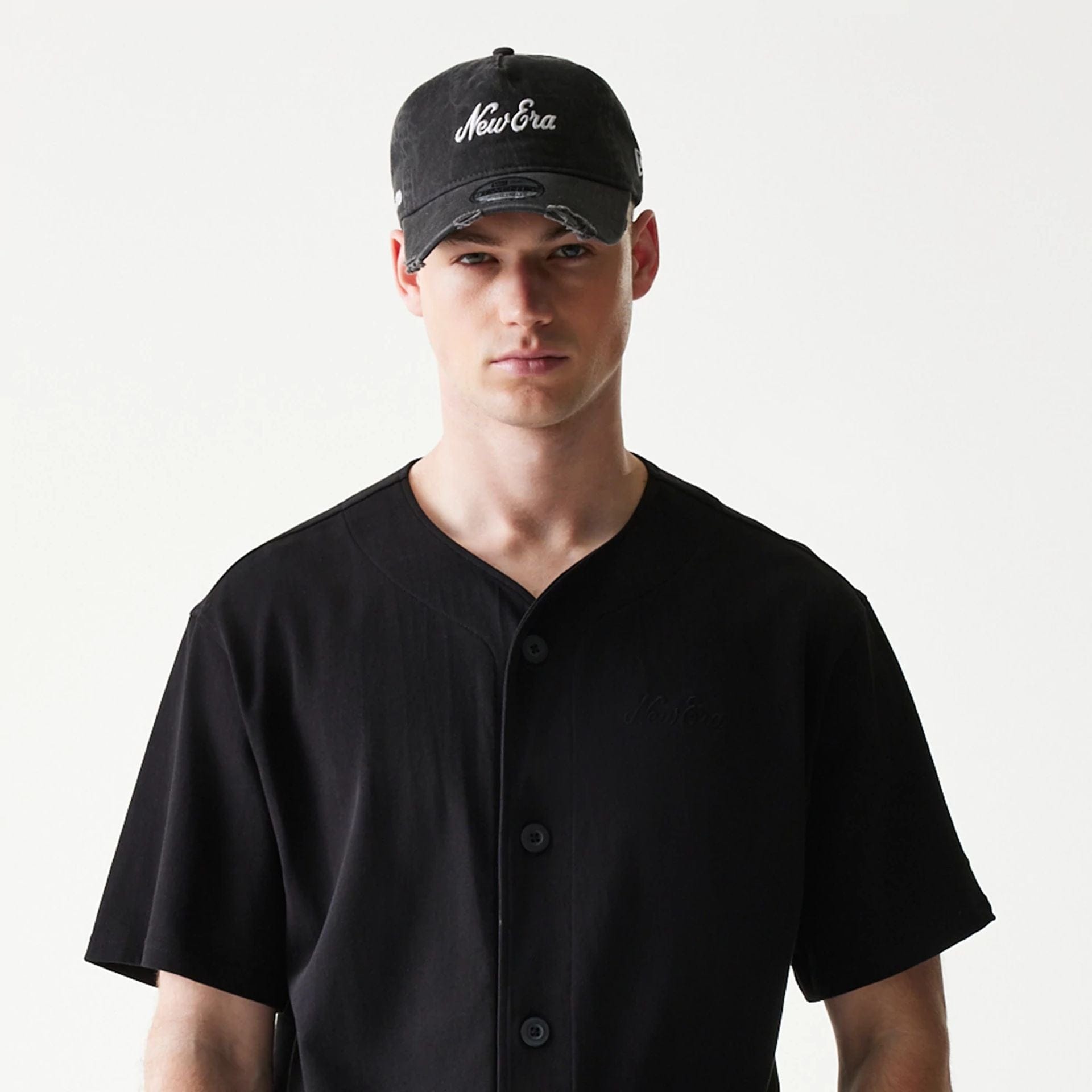 The model is wearing this New Era Script T-Shirt in black. 6
