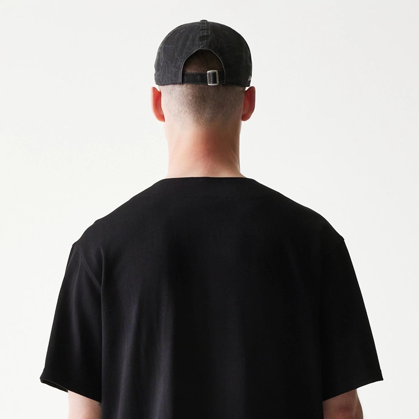 The model is wearing this New Era Script T-Shirt in black. 7
