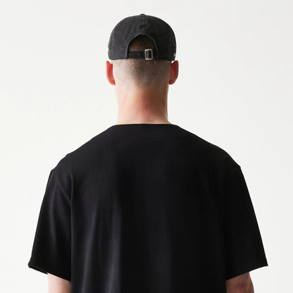 The model is wearing this New Era Script T-Shirt in black. 7