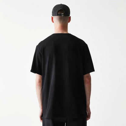 The model is wearing this New Era Script T-Shirt in black. 2