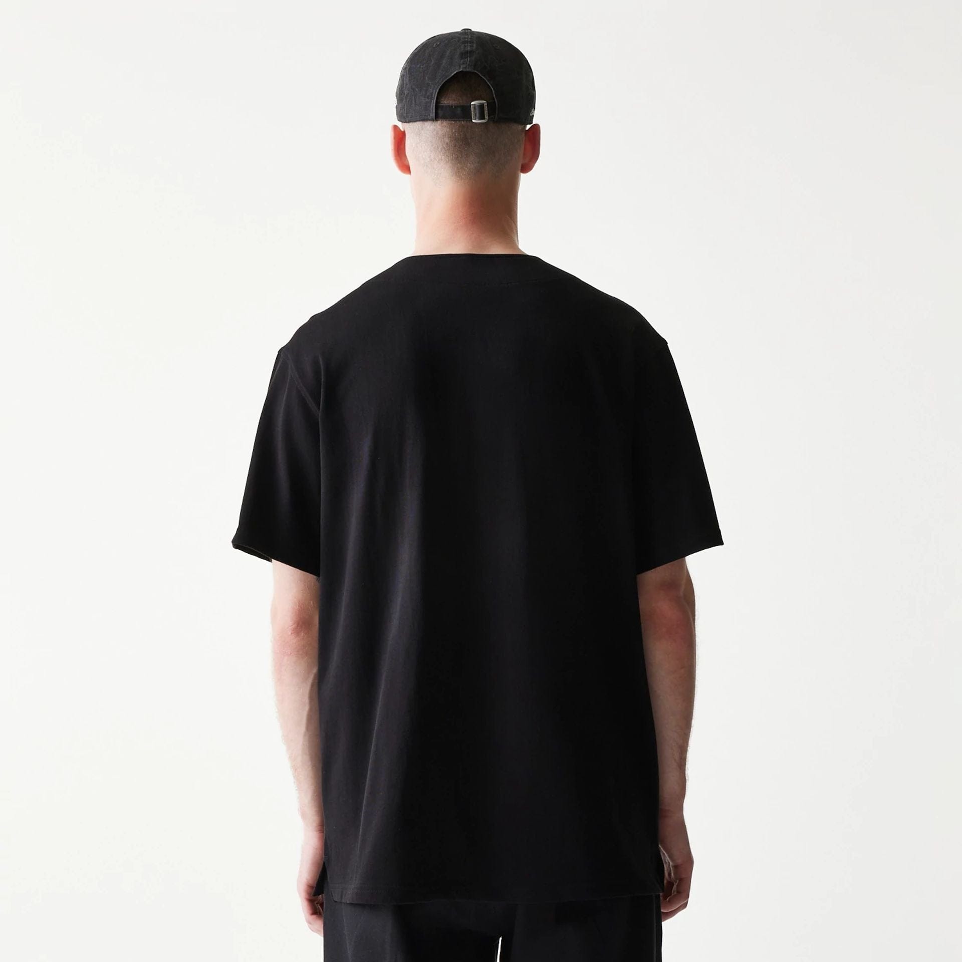 The model is wearing this New Era Script T-Shirt in black. 2
