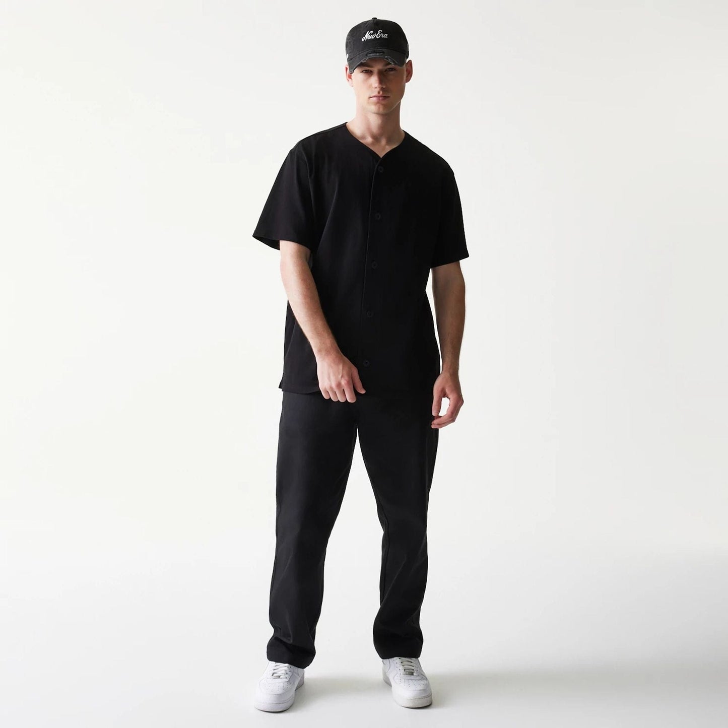 The model is wearing this New Era Script T-Shirt in black. 8