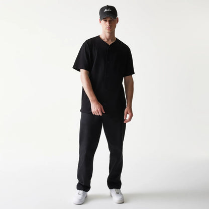 The model is wearing this New Era Script T-Shirt in black. 8