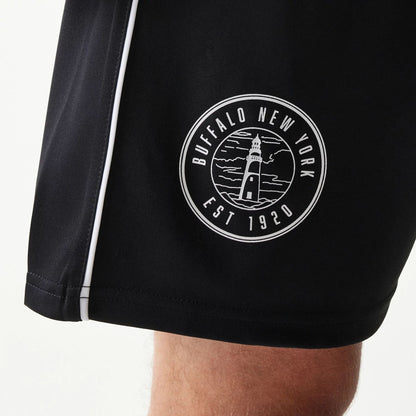 The model is wearing this New Era Football Shorts in black. 4