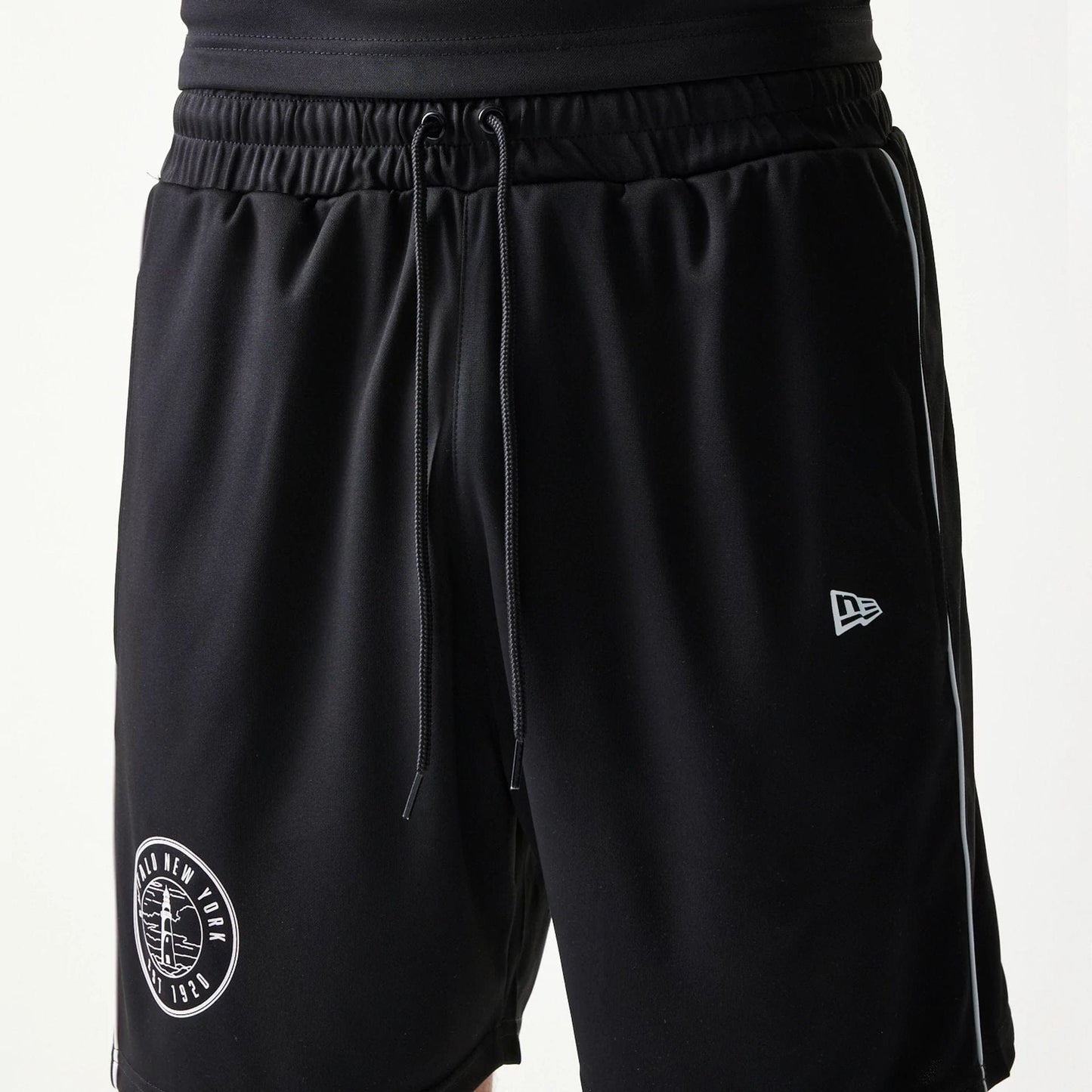The model is wearing this New Era Football Shorts in black. 6