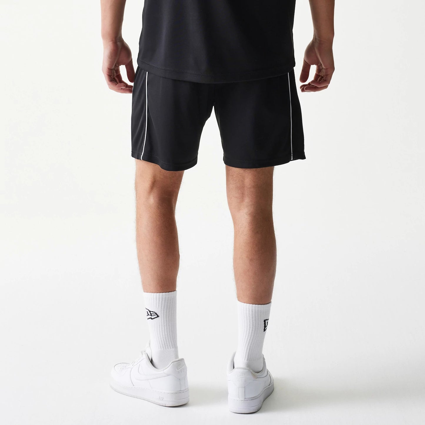 The model is wearing this New Era Football Shorts in black. 2