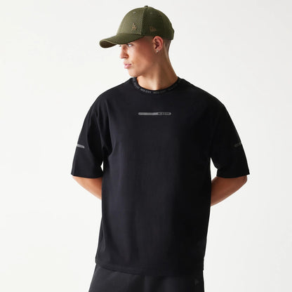 The model is wearing this New Era Tech Oversized T-Shirt in black. 1