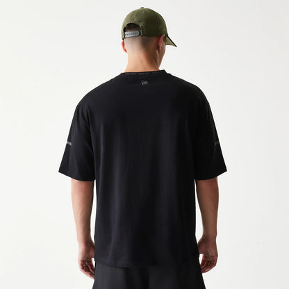 The model is wearing this New Era Tech Oversized T-Shirt in black. 2
