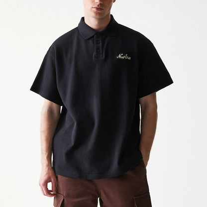 The model is wearing this New Era Graphic Polo T-Shirt in black. 3