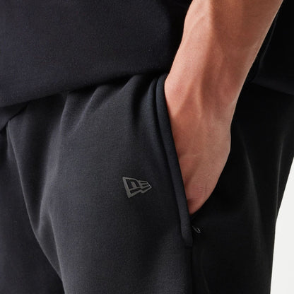 The model is wearing this New Era Tech Shorts in black. 4