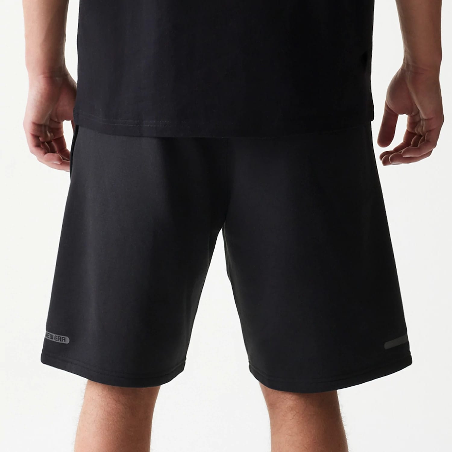 The model is wearing this New Era Tech Shorts in black. 6