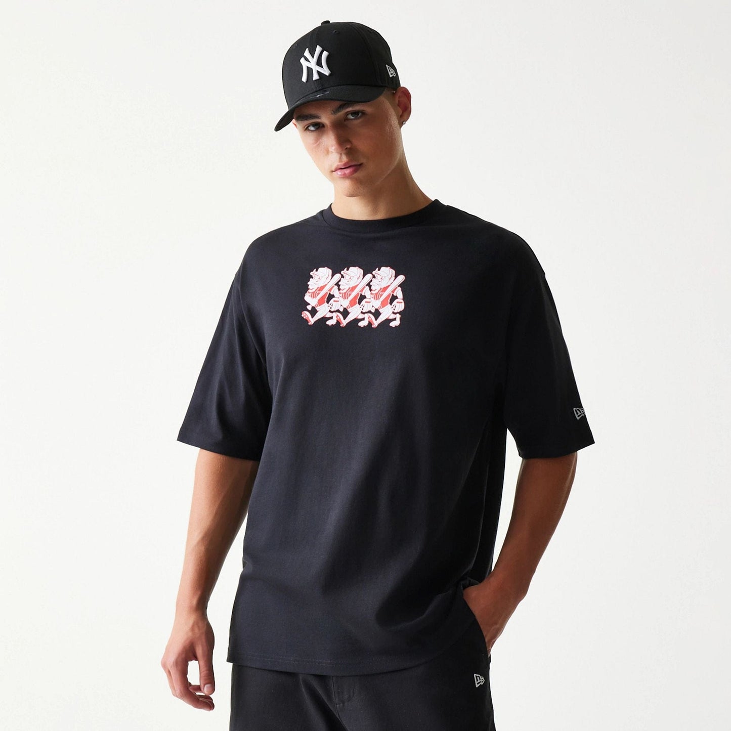 The model is wearing this New Era Baseball Cows Character Graphic Oversized T-Shirt in black. 3