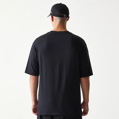 The model is wearing this New Era Lemon Fruit Graphic Oversized T-Shirt in black. 2