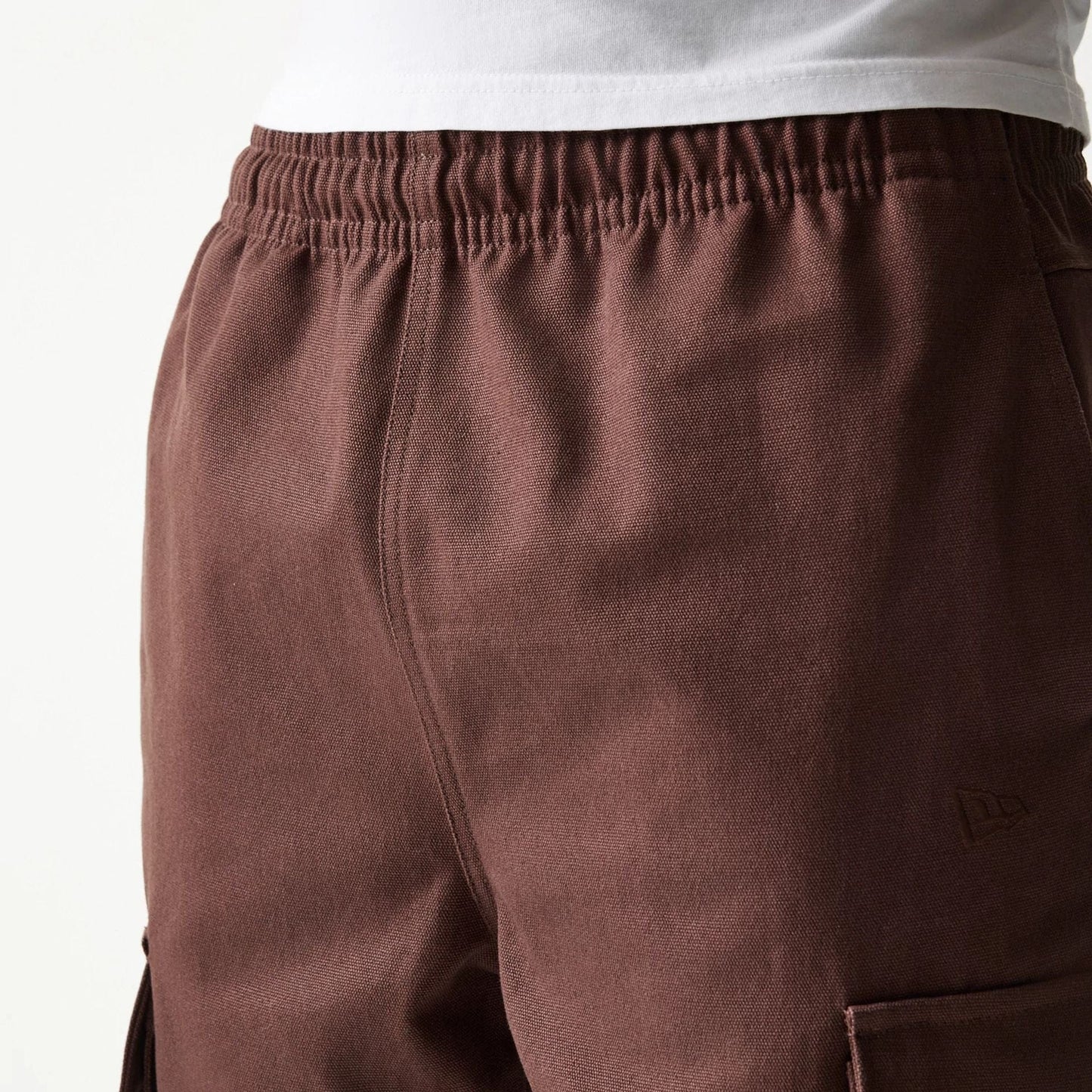 The model is wearing this New Era Straight Leg Cargo Joggers in brown. 7