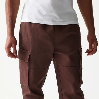 The model is wearing this New Era Straight Leg Cargo Joggers in brown. 3