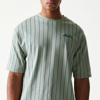 The model is wearing this New Era Pinstripe Oversized T-Shirt in pastel green. 3