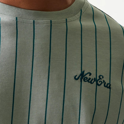 The model is wearing this New Era Pinstripe Oversized T-Shirt in pastel green. 6