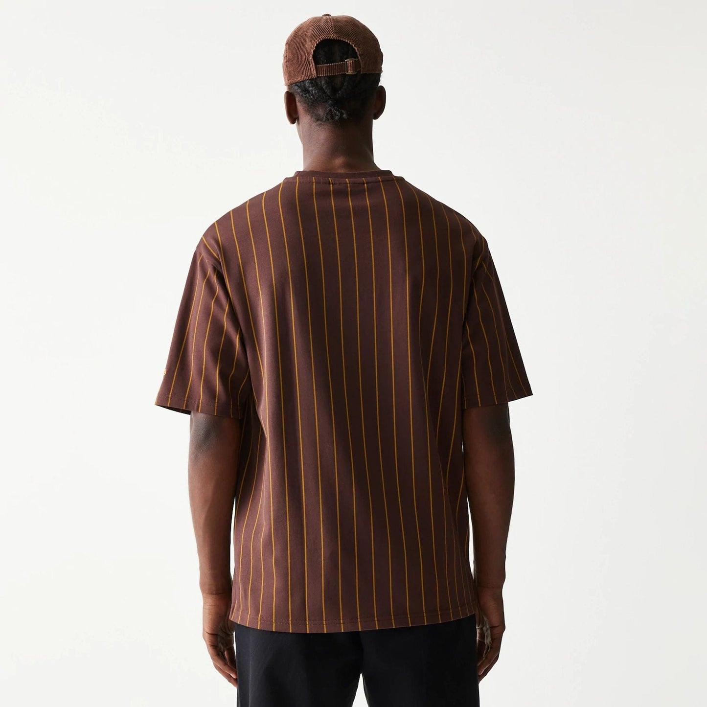 The model is wearing this New Era Pinstripe Oversized T-Shirt in brown. 2