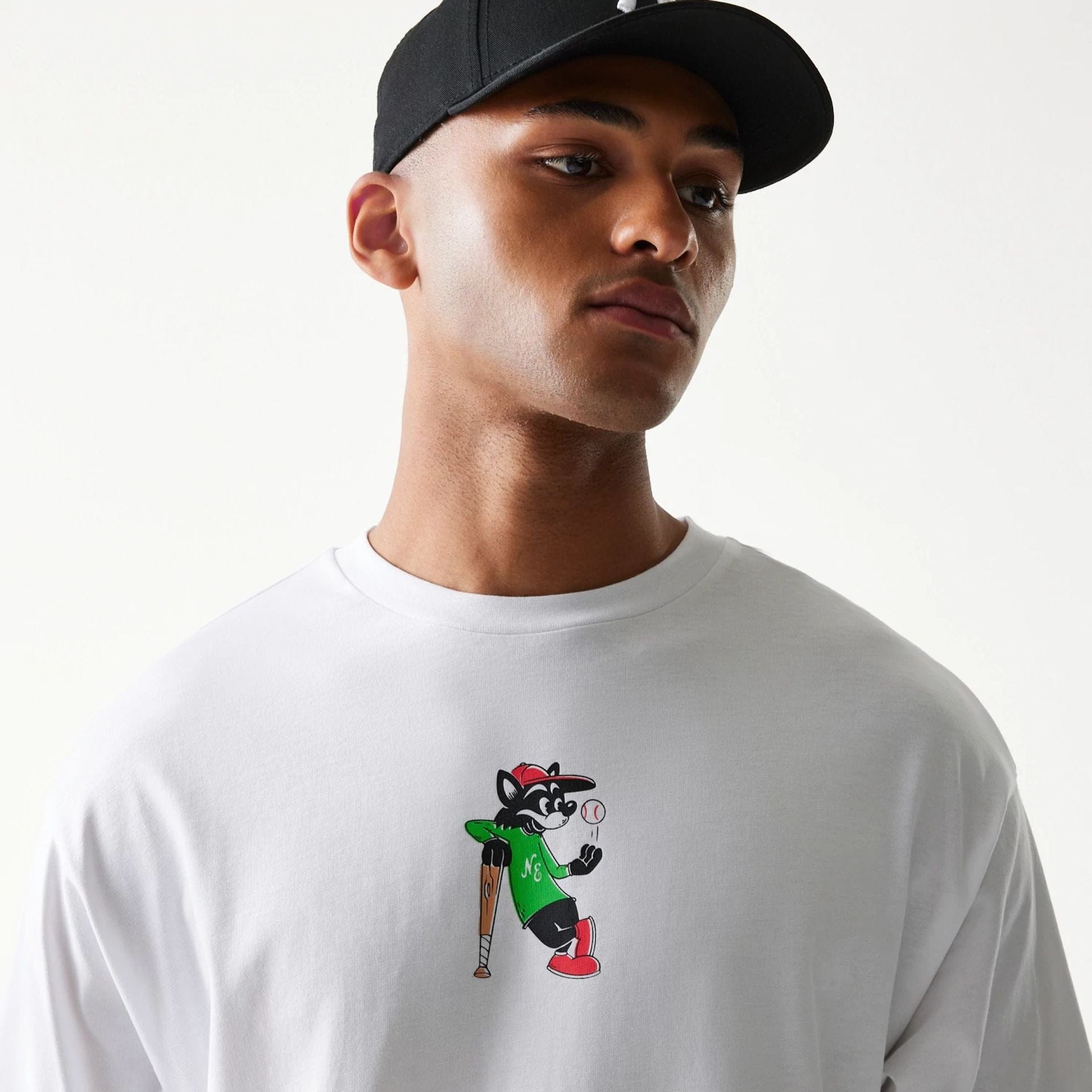 The model is wearing this New Era Baseball Cat Character Graphic Oversized T-Shirt in white. 6