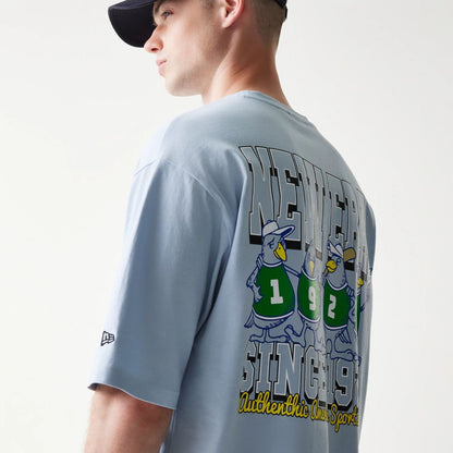 The model is wearing this New Era Baseball Birds Character Graphic Oversized T-Shirt in pastel blue. 7