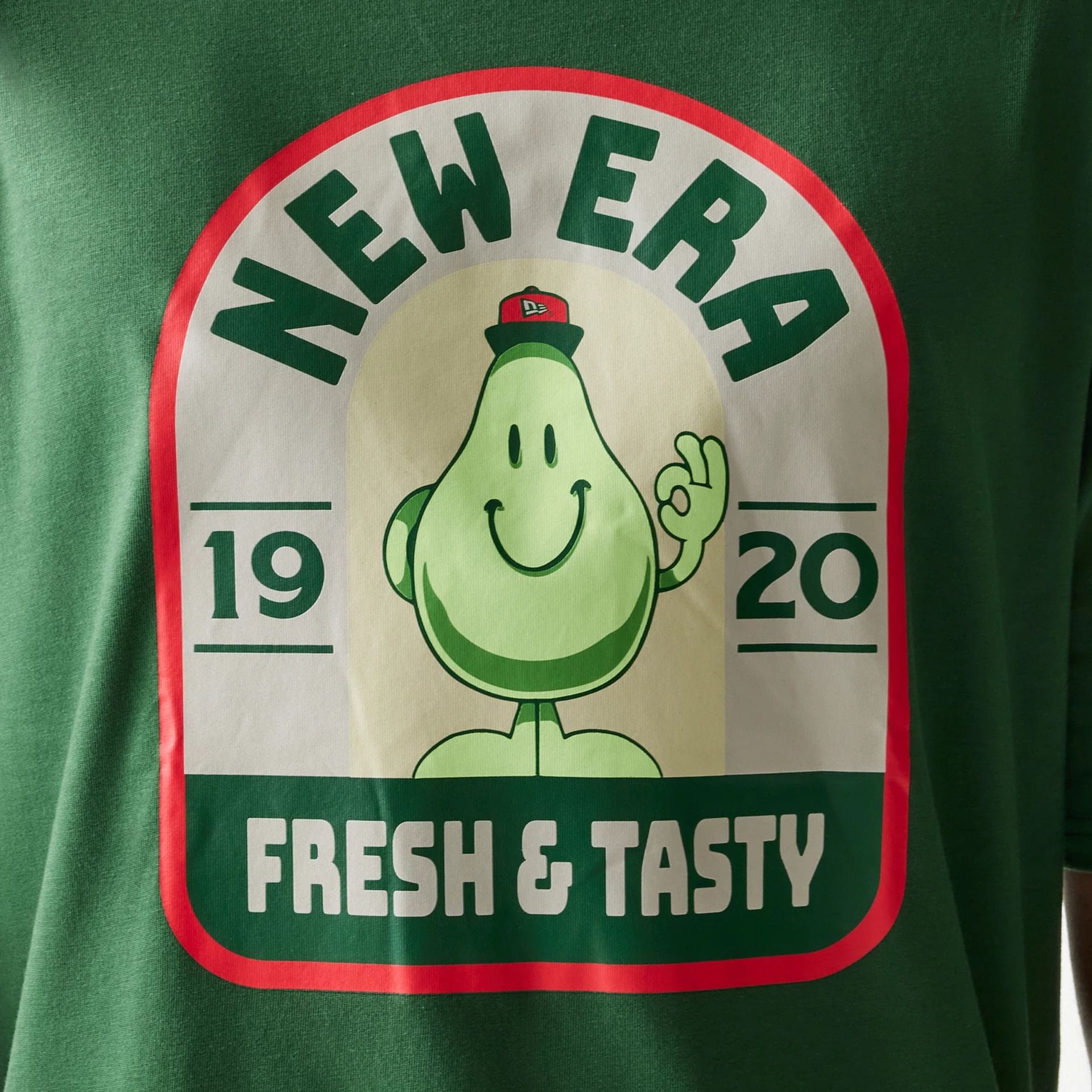 The model is wearing this New Era Pear Fruit Graphic Oversized T-Shirt in dark green. 6