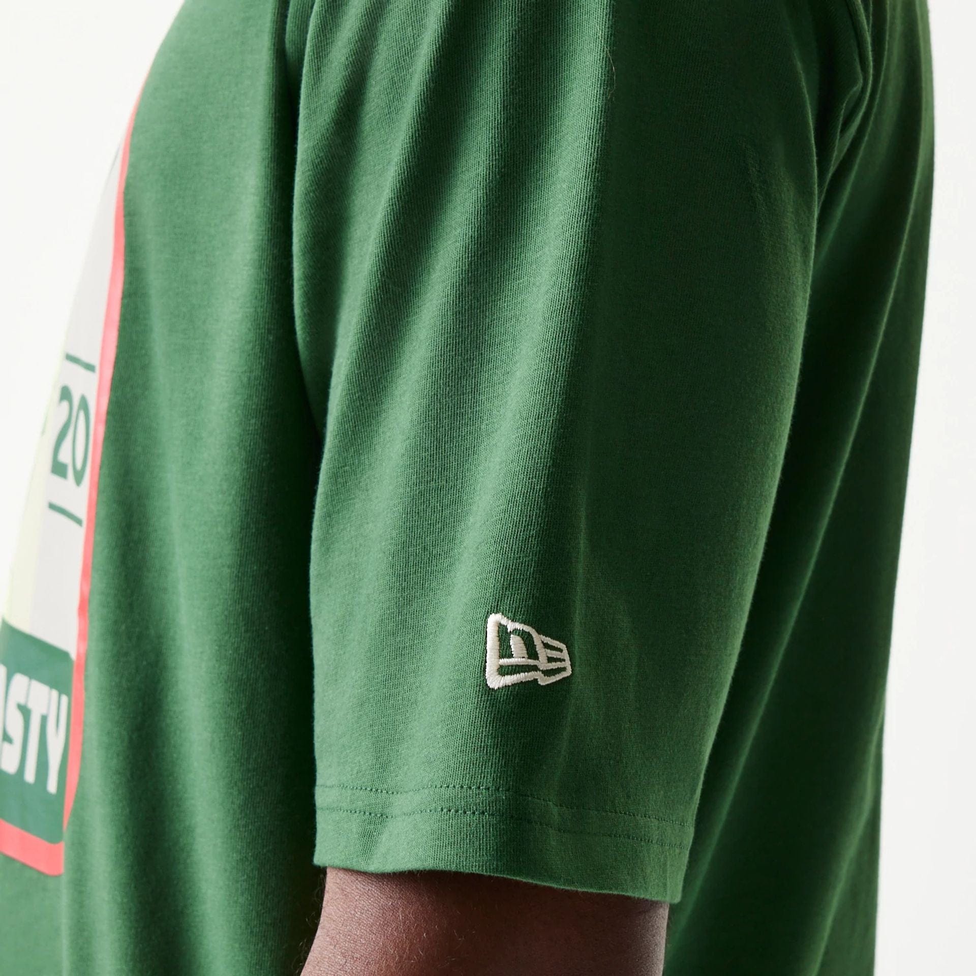 The model is wearing this New Era Pear Fruit Graphic Oversized T-Shirt in dark green. 7