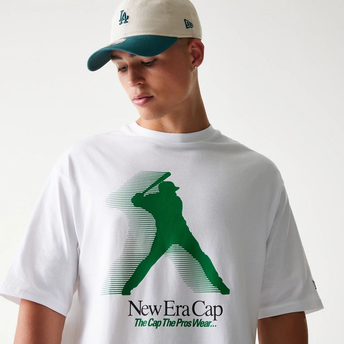 The model is wearing this New Era Baseball Player Graphic Oversized T-Shirt in white. 6