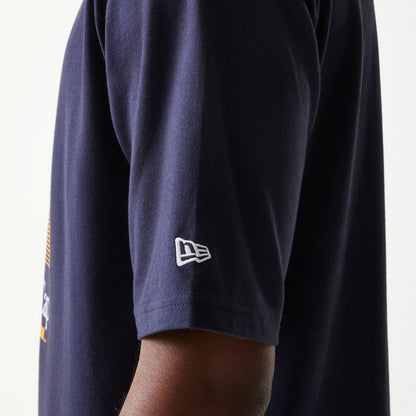 The model is wearing this New Era Baseball Player Graphic Oversized T-Shirt in navy. 5