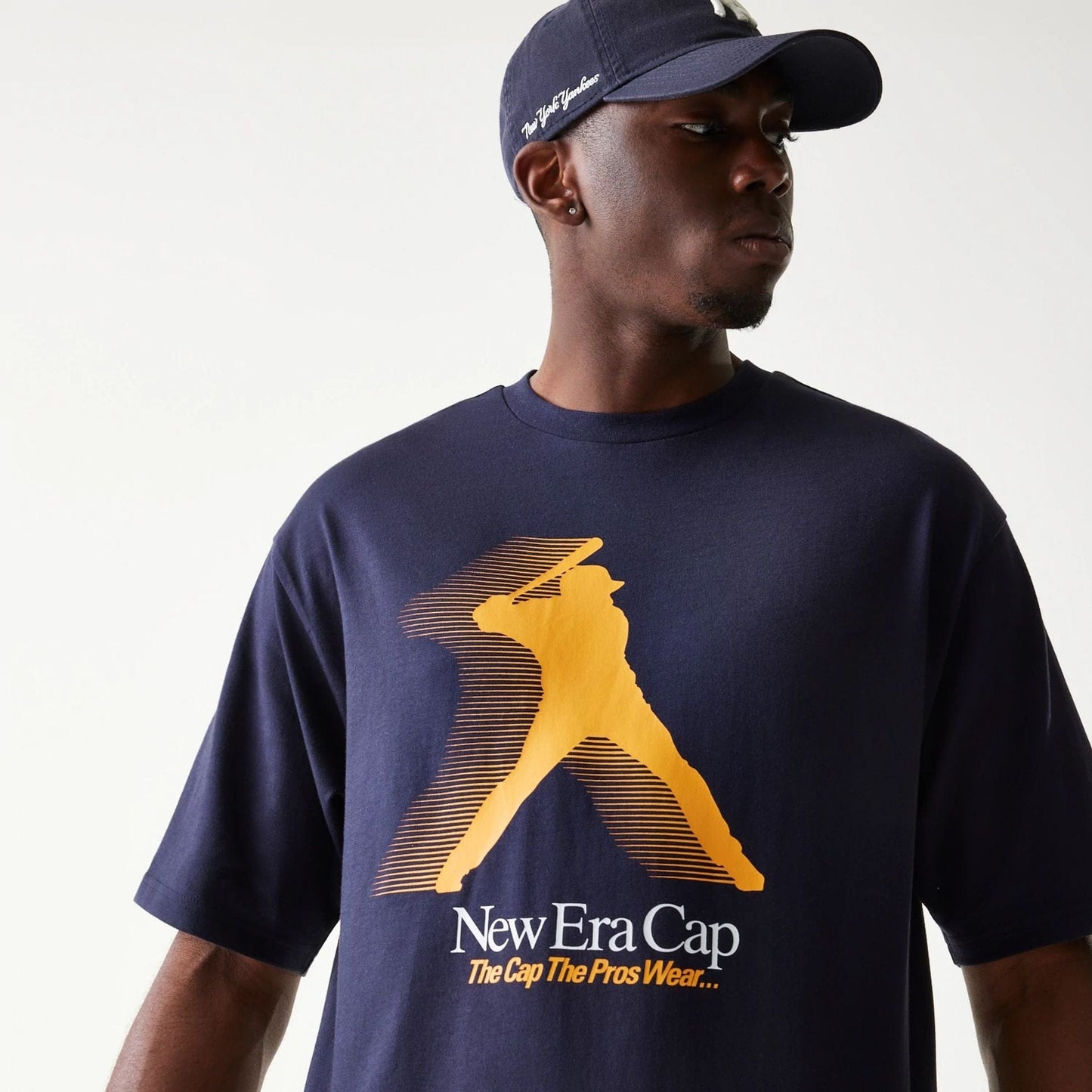 The model is wearing this New Era Baseball Player Graphic Oversized T-Shirt in navy. 6