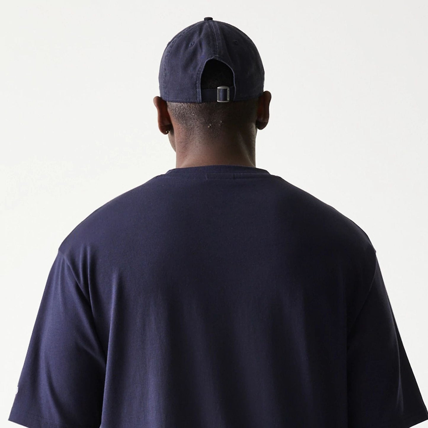 The model is wearing this New Era Baseball Player Graphic Oversized T-Shirt in navy. 7