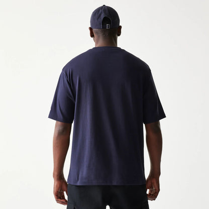 The model is wearing this New Era Baseball Player Graphic Oversized T-Shirt in navy. 2