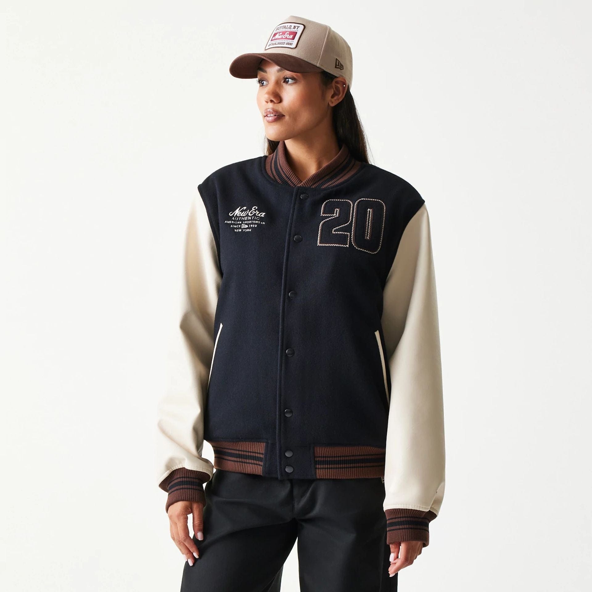 The model is wearing this New Era Varsity Jacket in black. 4