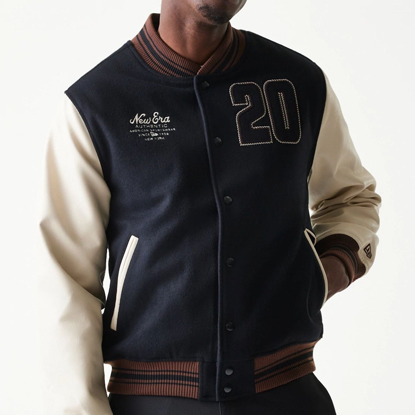 The model is wearing this New Era Varsity Jacket in black. 5