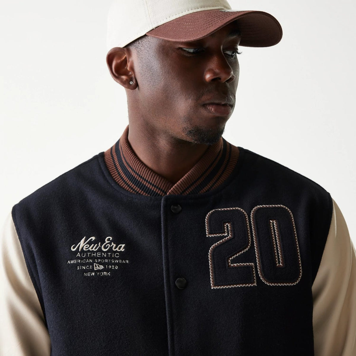 The model is wearing this New Era Varsity Jacket in black. 6