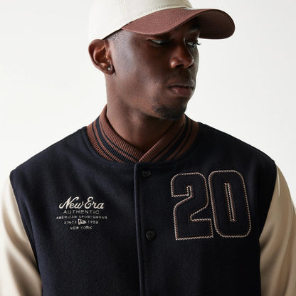 The model is wearing this New Era Varsity Jacket in black. 6