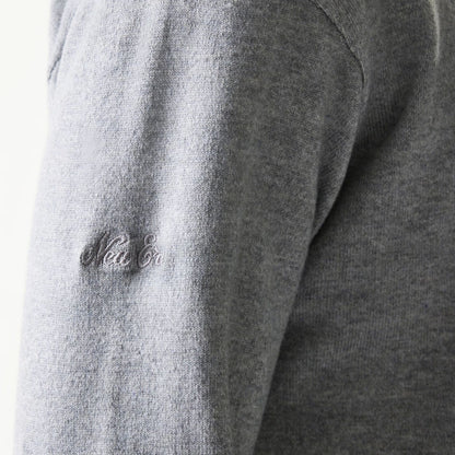 The model is wearing this New Era Essential Flag Knitted Sweater in grey. 8