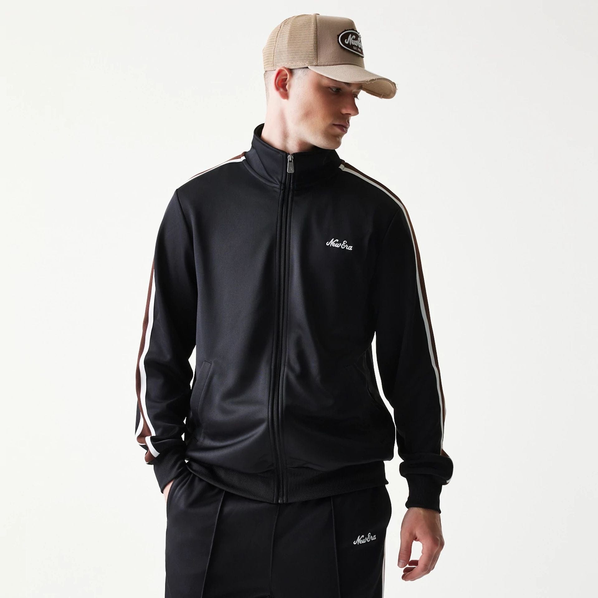 The model is wearing this New Era Script Track Jacket in black. 3