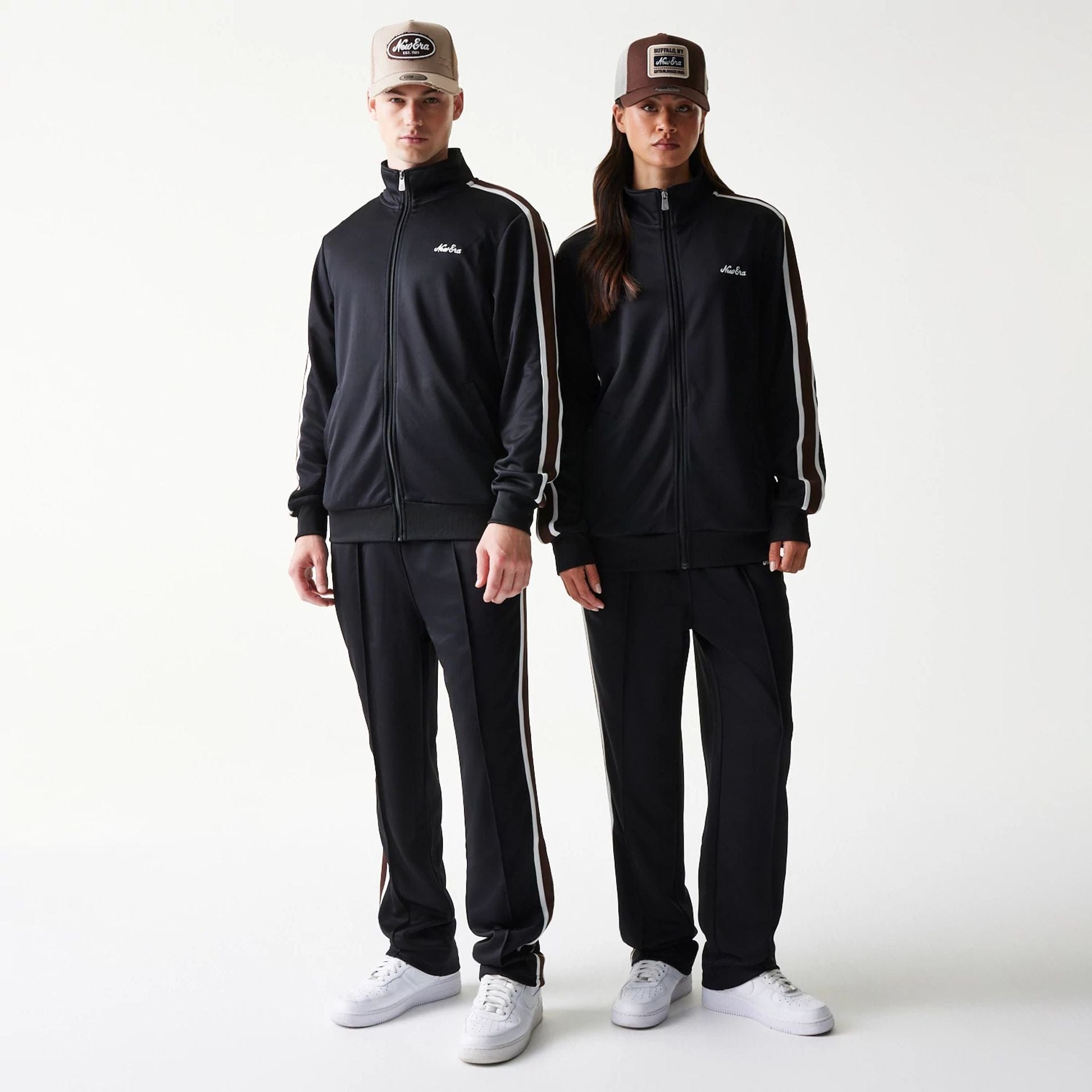 The model is wearing this New Era Script Track Jacket in black. 1