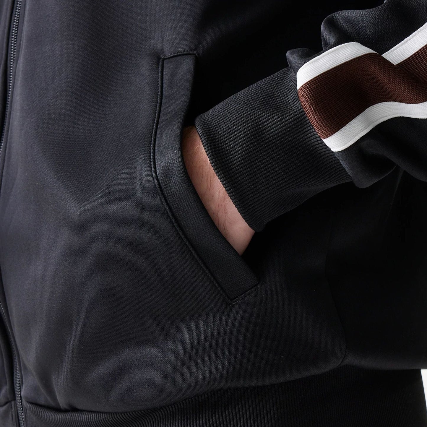 The model is wearing this New Era Script Track Jacket in black. 6