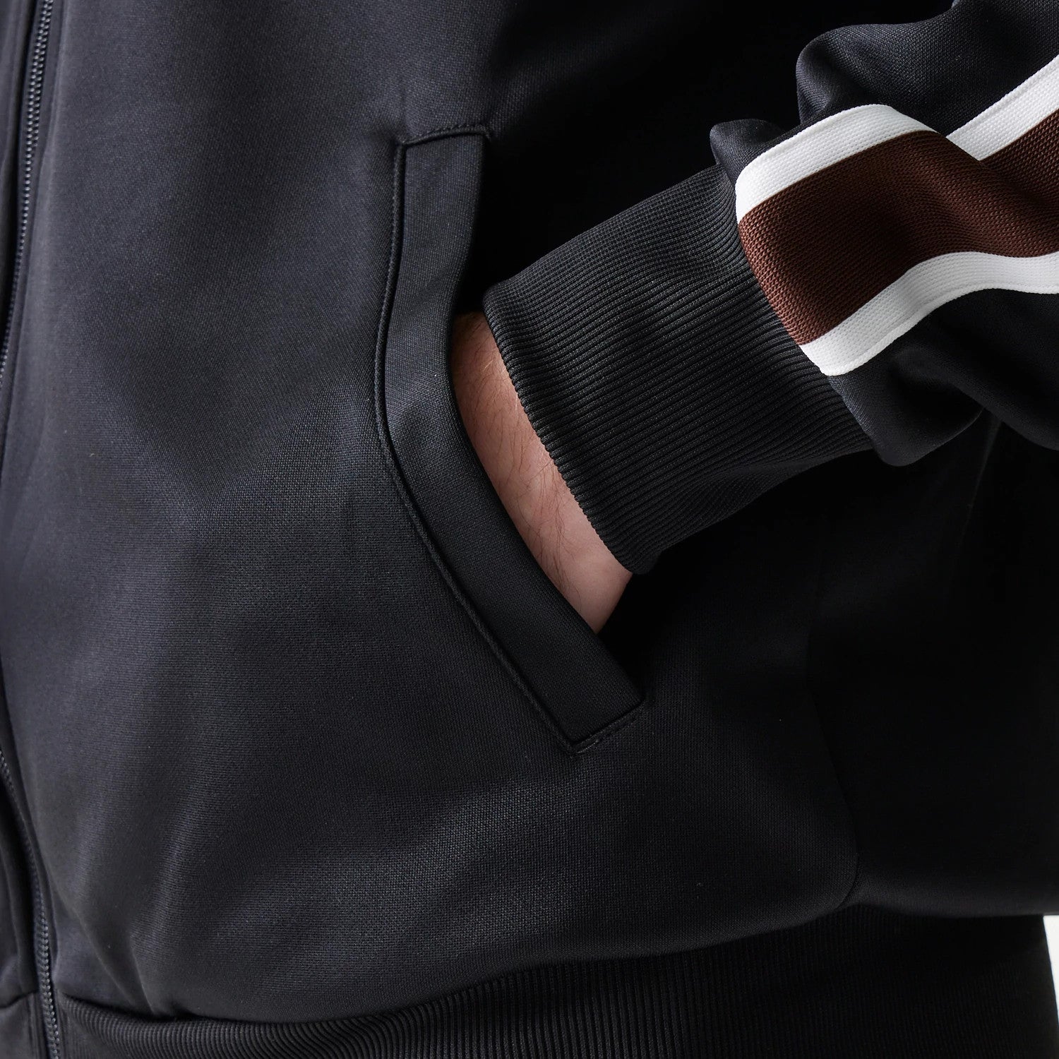 The model is wearing this New Era Script Track Jacket in black. 6