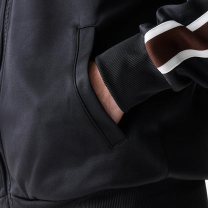 The model is wearing this New Era Script Track Jacket in black. 6