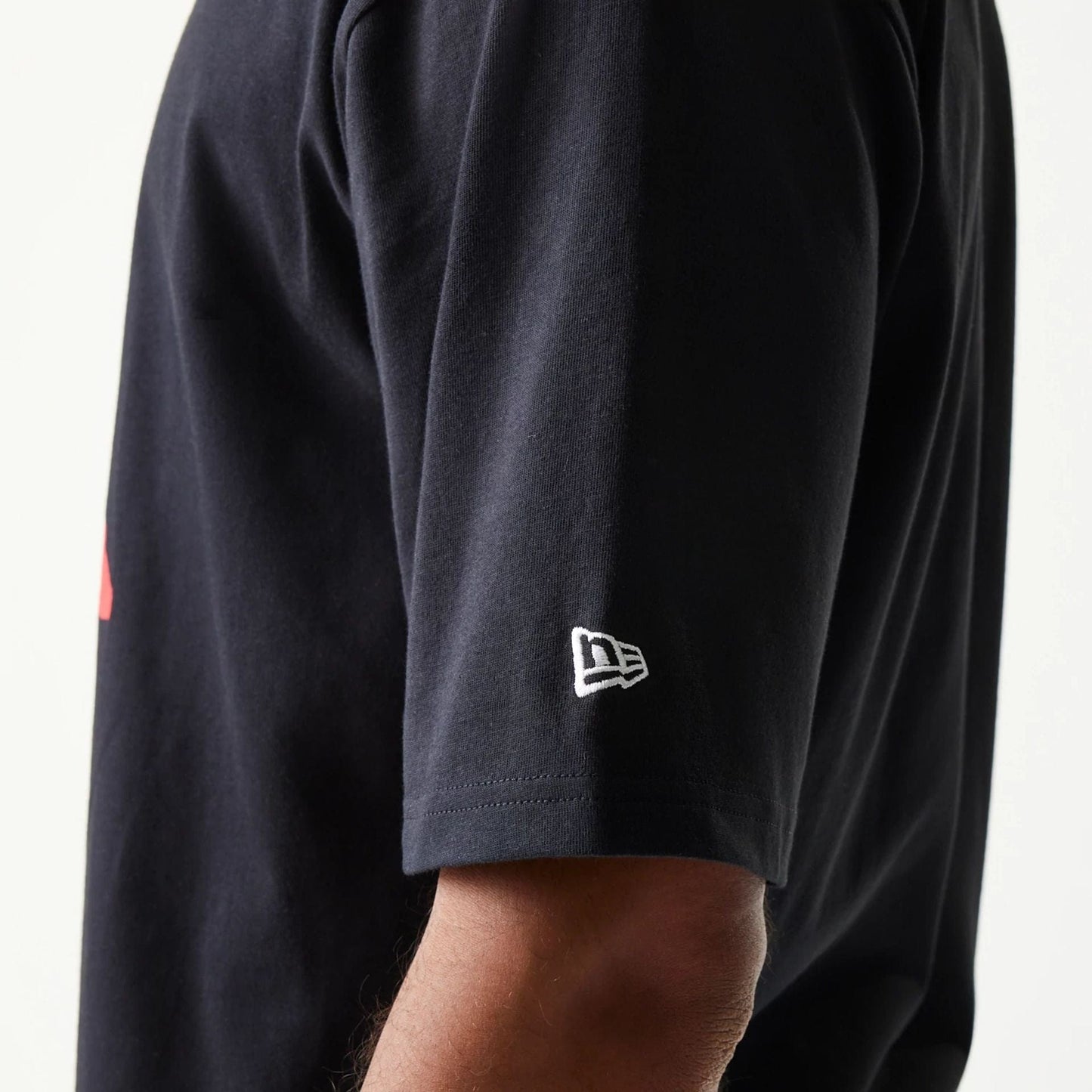 The model is wearing this New Era Baseball Player Graphic Oversized T-Shirt in black. 5