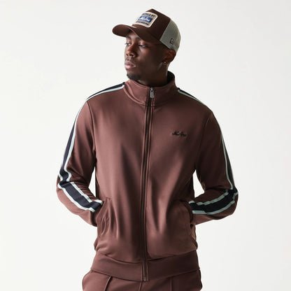 The model is wearing this New Era Script Track Jacket in brown. 3