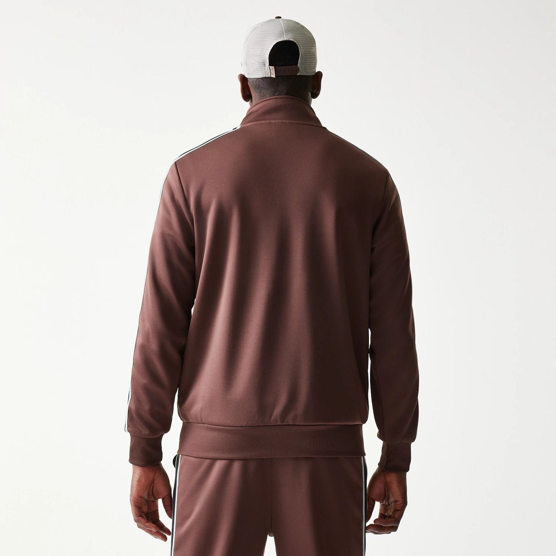 The model is wearing this New Era Script Track Jacket in brown. 2