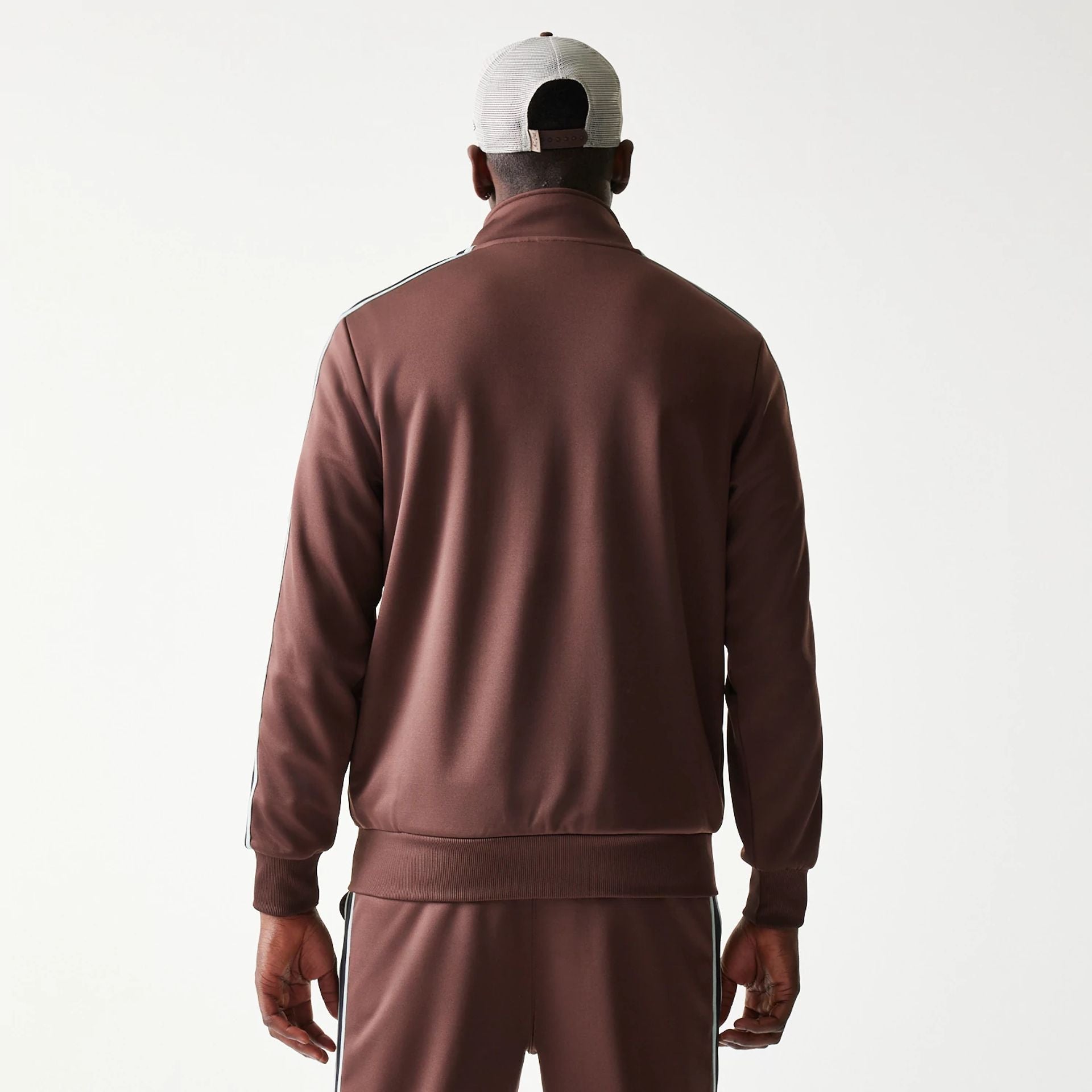 The model is wearing this New Era Script Track Jacket in brown. 2
